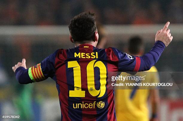 Barcelona's Argentinian forward Lionel Messi celebrates after scoring his second goal during their UEFA Champions League football match against Apoel...