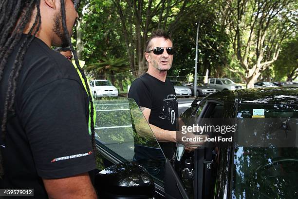 Drummer Phil Rudd talks to members of the media after leaving Tauranga District Court after appearing in court after being charged with threatening...
