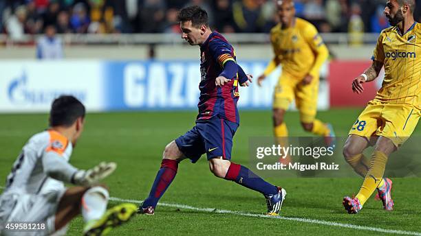 Lionel Messi of FC Barcelona scores the fourth goal during the Champions League match between Apoel FC and FC Barcelona at GSP Stadium on November...