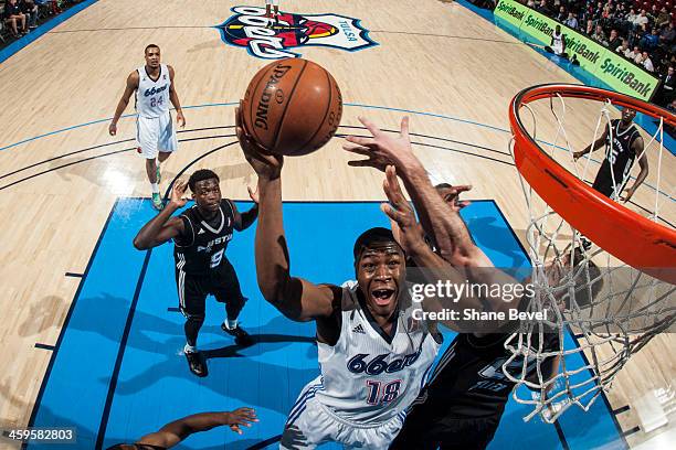 Ben Uzoh of the Tulsa 66ers shoots against Luke Zeller # of the Austin Toros during the NBA D-League game on December 27, 2013 at the Spirit Bank...