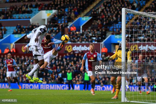 Roland Lamah of Swansea City heads in their first goal past Brad Guzan of Aston Villa during the Barclays Premier League match between Aston Villa...