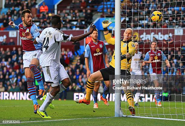 Roland Lamah of Swansea City heads in their first goal past Brad Guzan of Aston Villa during the Barclays Premier League match between Aston Villa...