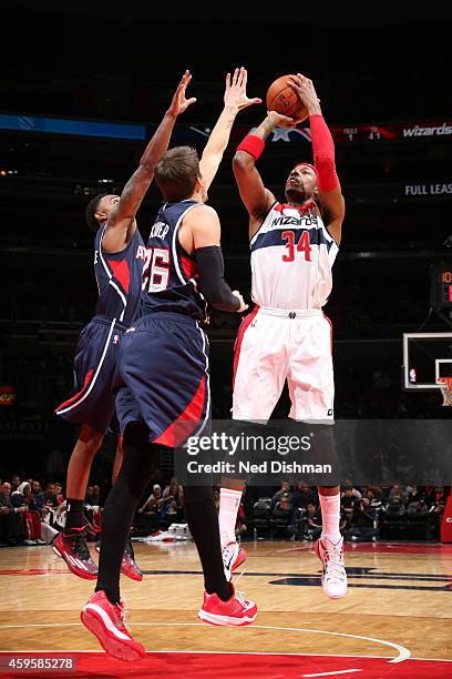 Paul Pierce of the Washington Wizards shoots against Kyle Korver of the Atlanta Hawks on November 25, 2014 at the Verizon Center in Washington, DC....