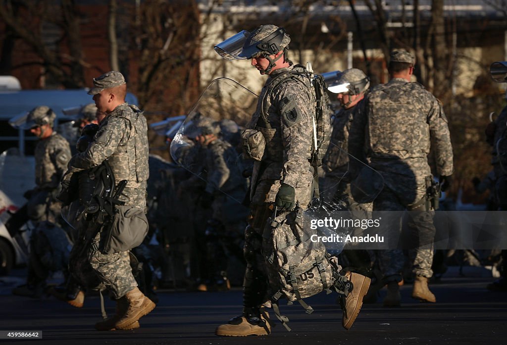 National Guard troops secure the police station in Ferguson...