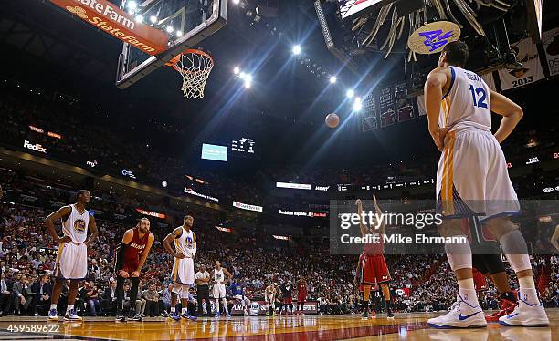 Shabazz Napier of the Miami Heat shoots a foul shot during a game against the Golden State Warriors at American Airlines Arena on November 25, 2014...