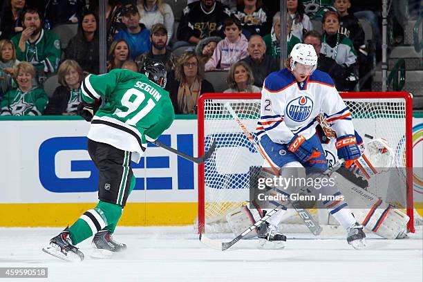 Tyler Seguin of the Dallas Stars rifles in a goal for his second of the game against Jeff Petry of the Edmonton Oilers at the American Airlines...