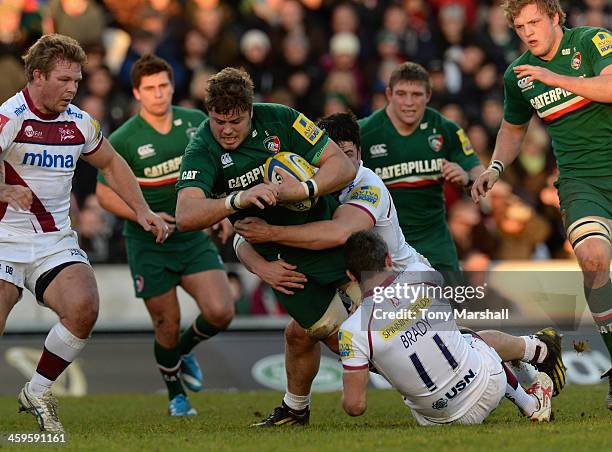 Ed Slater of Leicester Tigers is tackled by Marc Jones and Tom Brady of Sale Sharks during the Aviva Premiership match between Leicester Tigers and...