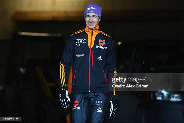 Martin Schmitt of Germany smlies as he prepares for the training round on day 1 of the Four Hills Tournament Ski Jumping event at...