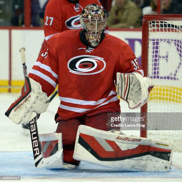 Justin Peters of the Carolina Hurricanes protects the net against the Pittsburgh Penguins at PNC Arena on December 27, 2013 in Raleigh, North...