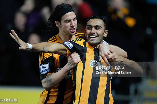 George Boyd of Hull City congratulates team-mate Ahmed Elmohamady after scoring a goal during the Barclays Premier League match between Hull City and...