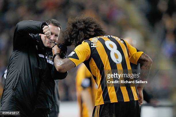 Tom Huddlestone of Hull city celebrates after scoring the team's 4th goal by having his hair cut after vowing to not have his hair cut until he...