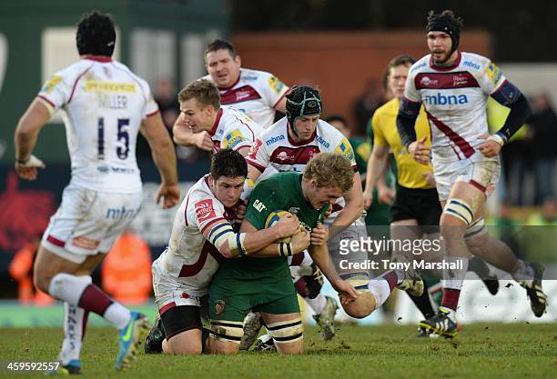 Jamie Gibson of Leicester Tigers tackled by James Gaskell and Marc Jones of Sale Sharks during the Aviva Premiership match between Leicester Tigers...