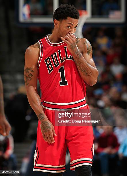 Derrick Rose of the Chicago Bulls pauses during a break in the action against the Denver Nuggets at Pepsi Center on November 25, 2014 in Denver,...