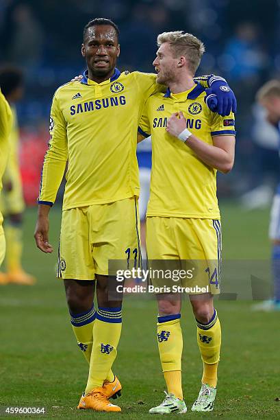 Didier Drogba and Andre Schuerrle of Chelsea hug after winning the UEFA Champions League Group G match between FC Schalke 04 and Chelsea FC at...