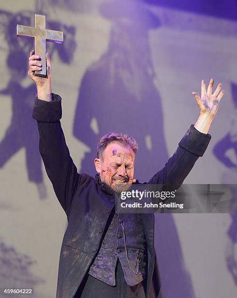 Jason Donovan as Parson Nathaniel performs during a dress rehearsal for 'War of the Worlds' on November 25, 2014 in London, England.