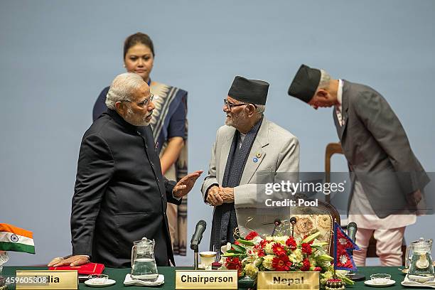 Narendra Modi, Prime Minister of India, speaks to Sushil Koirala, Prime Minister of Nepal, during the inaugural session of the 18th SAARC Summit on...