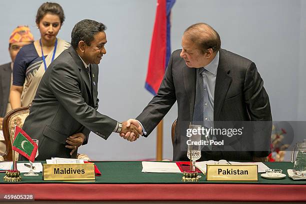 Abdulla Yameen, President of the Maldives, greets Nawaz Sharif, Prime Minister of Pakistan, during the inaugural session of the 18th SAARC Summit on...