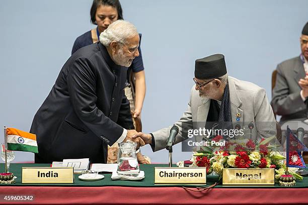 Narendra Modi, Prime Minister of India, greets Sushil Koirala, Prime Minister of Nepal, during the inaugural session of the 18th SAARC Summit on...