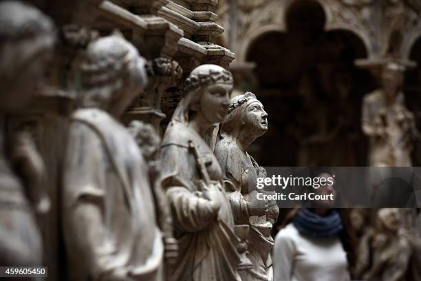 An employee walks past an exhibit entitled 'Tomb of St Peter Martyr' by Giovanni di Balduccio and dated 1338 during a press preview for the newly...