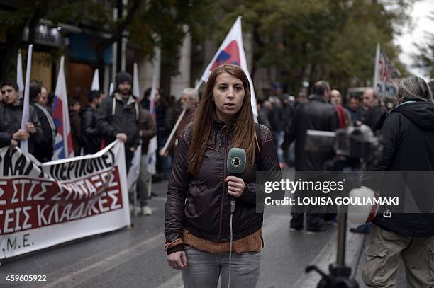 Foreign journalist reports on a media strike during a rally outside the journalists union in central Athens on November 26, 2014. Greek journalists...