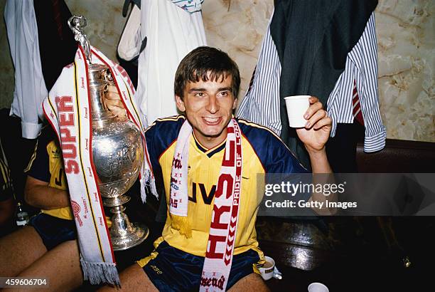 Arsenal goalscorer Alan Smith celebrates in the dressing room with the League Division One trophy after Arsenal had beaten Liverpool 2-0 in the final...