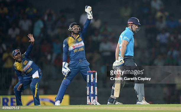 Mahela Jayawardena and Kumar Sangakkara of Sri Lanka successfully appeal for the wicket of England captain Alastair Cook during the 1st One Day...