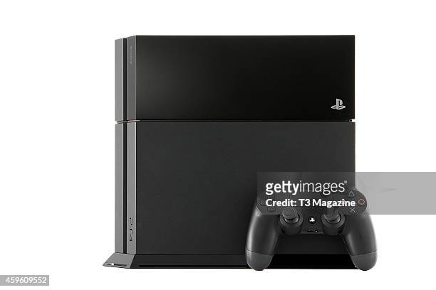 Sony PlayStation 4 video game console and DualShock 4 controller photographed on a white background, taken on November 12, 2013.