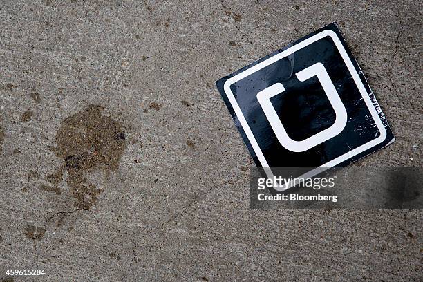 The Uber Technologies Inc. Logo is seen on the ground at Ronald Reagan National Airport in Washington, D.C., U.S., on Wednesday, Nov. 26, 2014. Uber...