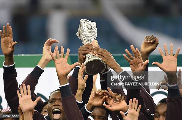 Qatar players celebrate with the Gulf cup trophy after defeating Saudi Arabia 2-1 in the final of the 22nd Gulf Cup football match at the King Fahad...