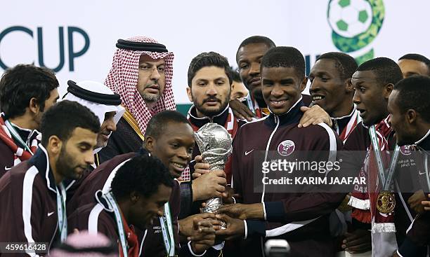 Qatar players receive the Gulf Cup tropy after defeating Saudi Arabia 2-1 in the final of the 22nd Gulf Cup football match at the King Fahad stadium...
