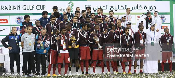 Qatar players pose with the Gulf Cup tropy after defeating Saudi Arabia 2-1 in the final of the 22nd Gulf Cup football match at the King Fahad...
