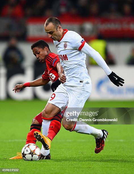 Wendell of Bayer Leverkusen tackles Dimitar Berbatov of Monaco during the UEFA Champions League group C match between Bayer 04 Leverkusen and AS...