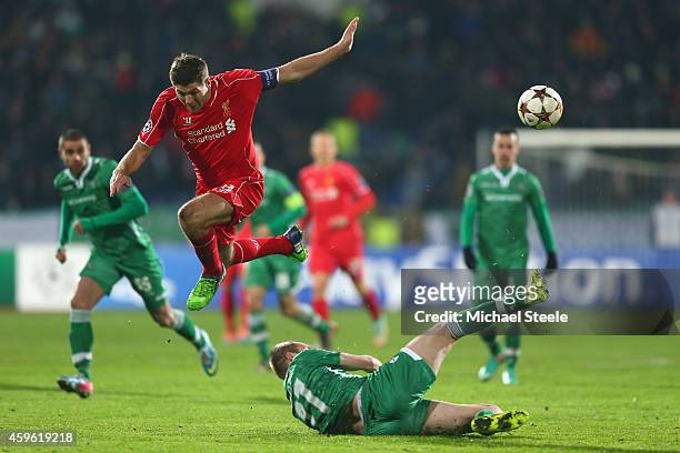Steven Gerrard of Liverpool is tackled by Cosmin Moti of Ludogerets during the UEFA Champions League Group B match between Ludogorets Razgrad and...