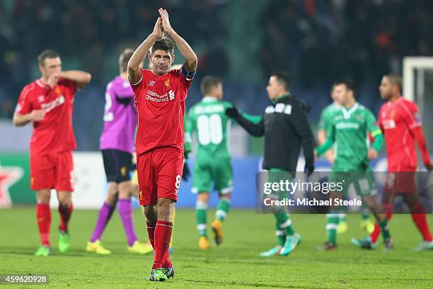 Steven Gerrard the captain of Liverpool applauds the travelling fans after his sides 2-2 draw during the UEFA Champions League Group B match between...