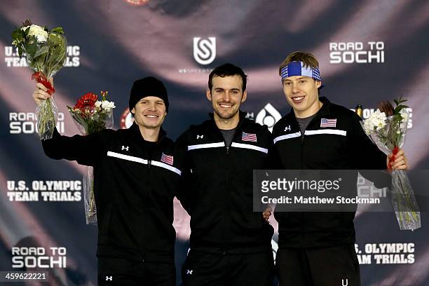 Tucker Fredricks, Mitchell Whitmore and Brian Hansen celebrate on the medals podium after the men's 500 meter during the U.S. Speed Skating Long...
