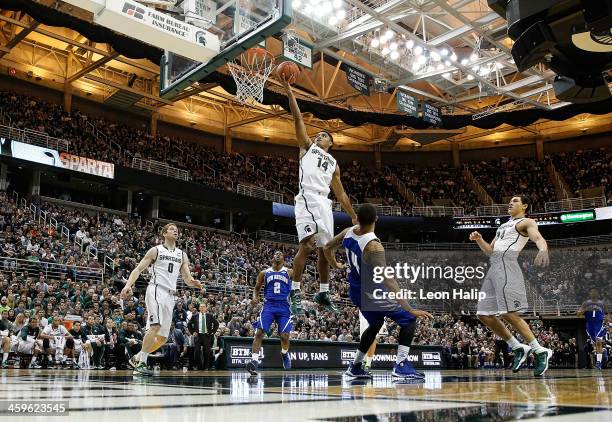 Gary Harris of the Michigan State Spartans drives the ball to the basket during the second half of the game as Cory Dixon of the New Orleans...