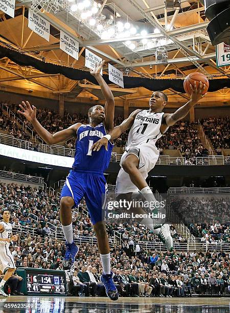 Keith Appling of the Michigan State Spartans drives the ball to the basket during the second half of the game as Tevin Broyles of the New Orleans...