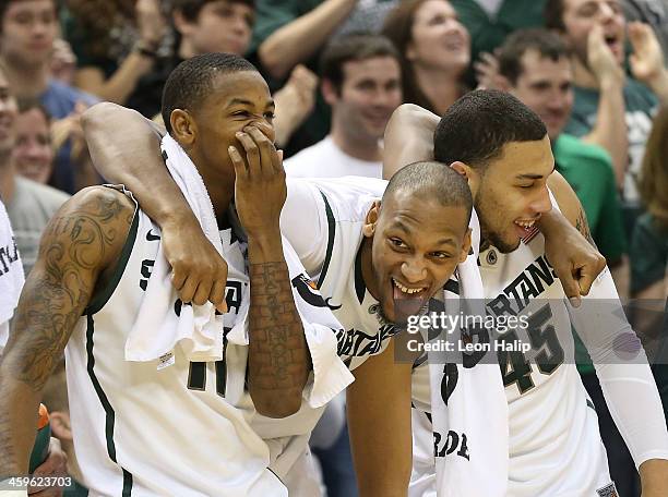 Keith Appling Adreian Payne and Denzel Valentine of the Michigan State Spartans celebrate a win over the New Orleans Privateers at the Breslin Center...