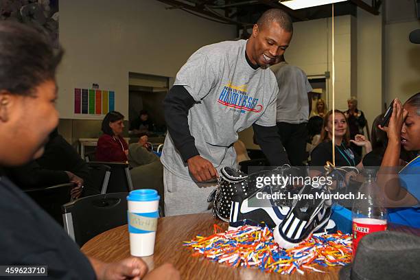 Sebastian Telfair of the Oklahoma City Thunder serves a holiday meal to clients at the City Rescue Mission and participates in a carnival for...