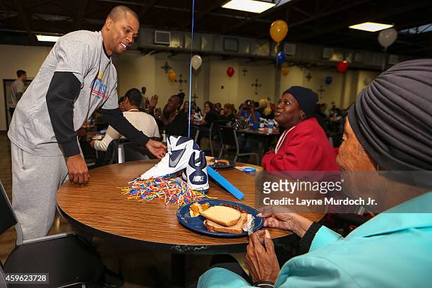 Sebastian Telefair of the Oklahoma City Thunder serves a holiday meal to clients at the City Rescue Mission and participates in a carnival for...