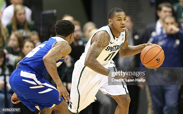 Keith Appling of the Michigan State Spartans brings the ball up the court during the second half of the game against the New Orleans Privateers at...