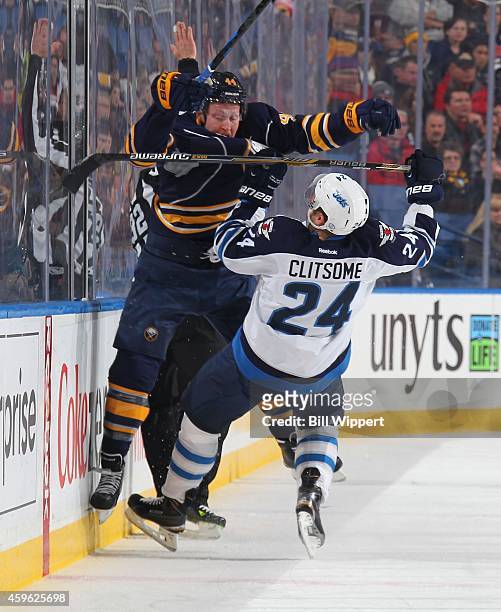 Nicolas Deslauriers of the Buffalo Sabres checks Grant Clitsome of the Winnipeg Jets on November 26, 2014 at the First Niagara Center in Buffalo, New...