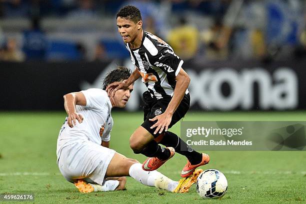 Douglas Santos of Atletico MG struggles for the ball with a Marcelo Moreno of Cruzeiro during a match between Atletico MG and Cruzeiro as part of...