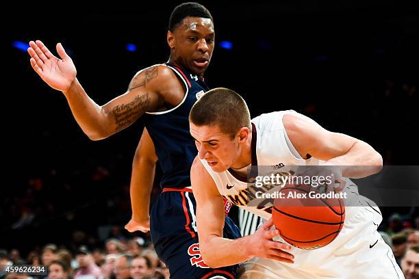 Christian Jones of the St. John's Red Storm guards Joey King of the Minnesota Golden Gophers in the first half at Madison Square Garden on November...