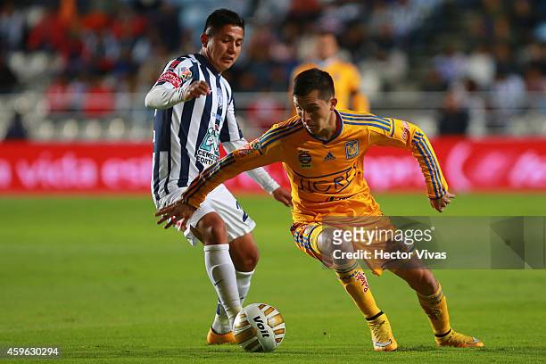 Jose Francisco Torres of Tigres struggles for the ball with Daniel Villalpando of Pachuca during a quarterfinal first leg match between Pachuca and...