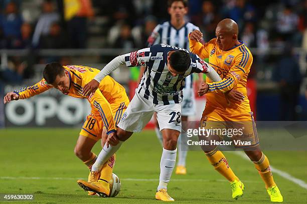 Jose Francisco Torres and Egidio Arevalo of Tigres struggle for the ball with Daniel Villalpando of Pachuca during a quarterfinal first leg match...