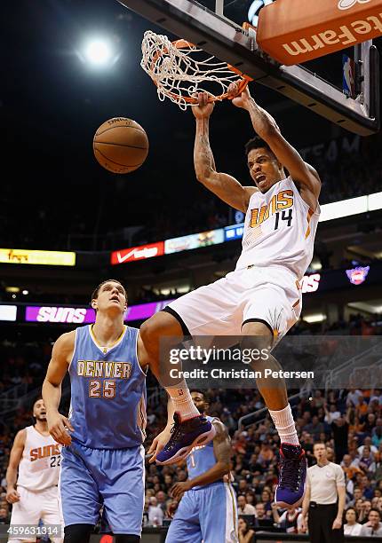 Gerald Green of the Phoenix Suns slam dunks the ball over Timofey Mozgov of the Denver Nuggets during the second half of the NBA game at US Airways...