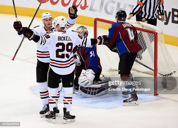 Bryan Bickell of the Chicago Blackhawks celebrates his goal against goalie Calvin Pickard of the Colorado Avalanche with teammate Jonathan Toews of...