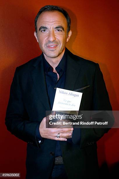 Host Nikos Aliagas presents his book "J'aimerais te dire" during the 'Vivement Dimanche' French TV Show at Pavillon Gabriel on November 26, 2014 in...