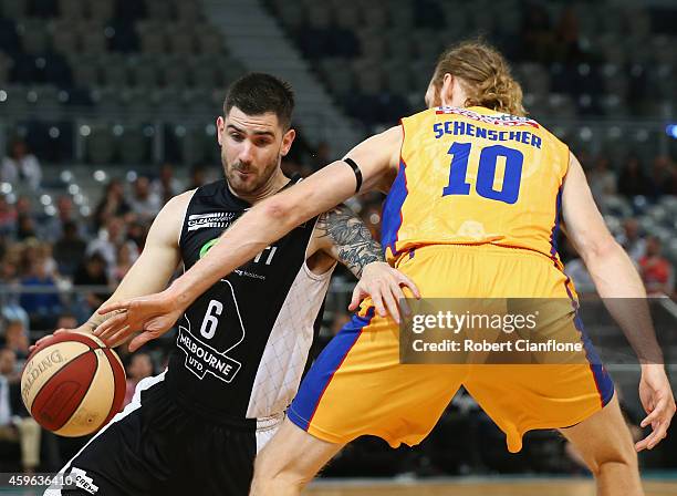 Nate Tomlinson of Melbourne United is challenged by Luke Schenscher of the Adelaide 36ers during the round eight NBL match between Melbourne United...